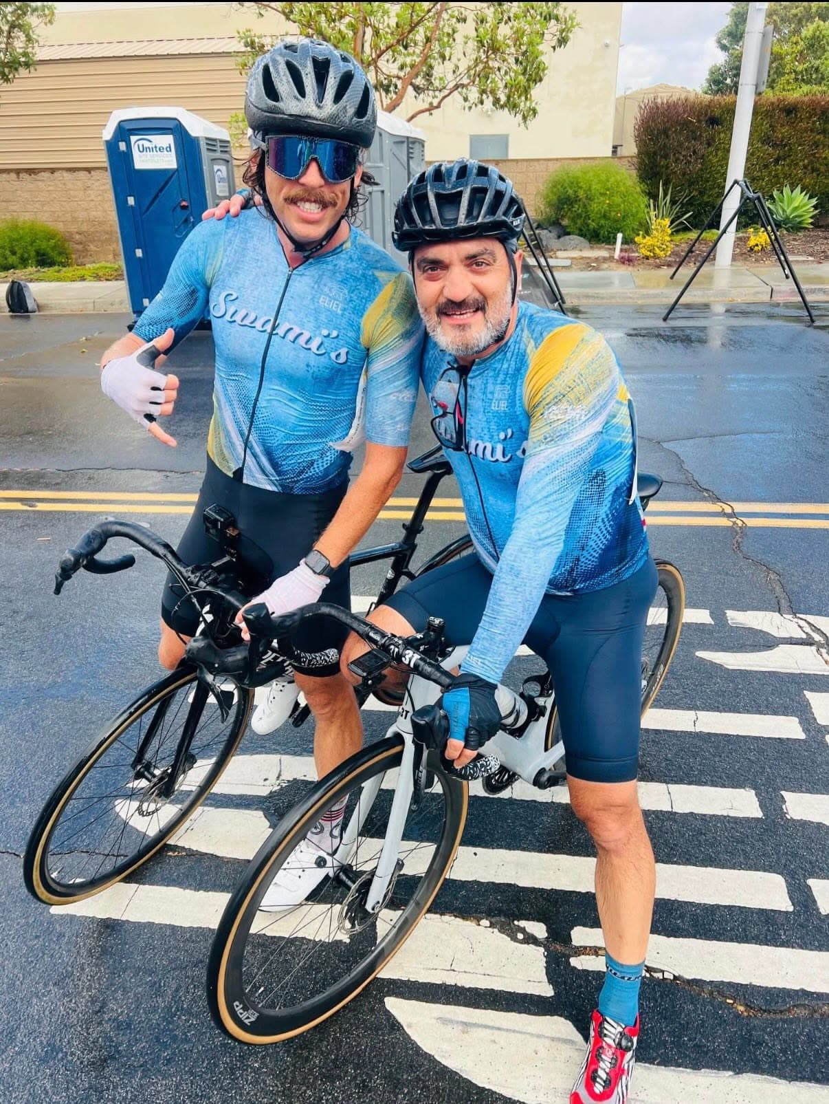 Two cyclists wearing Swami’s blue and gold main kit