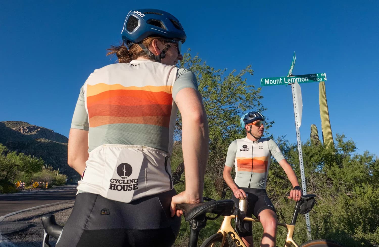 Front and back views of the kits beside the Mount Lemmon road sign
