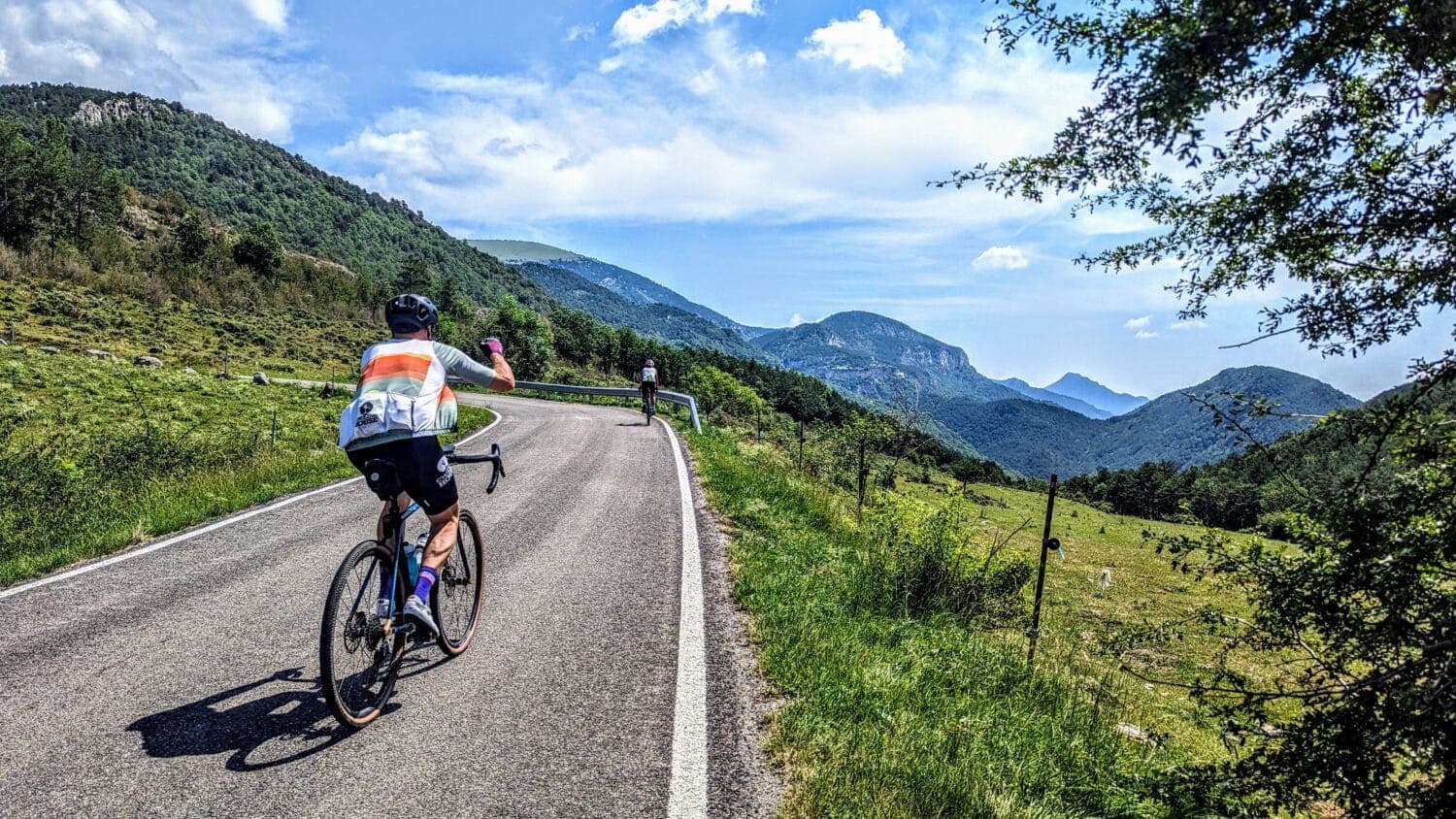Cyclist wearing the finished kit on a scenic green mountain climb