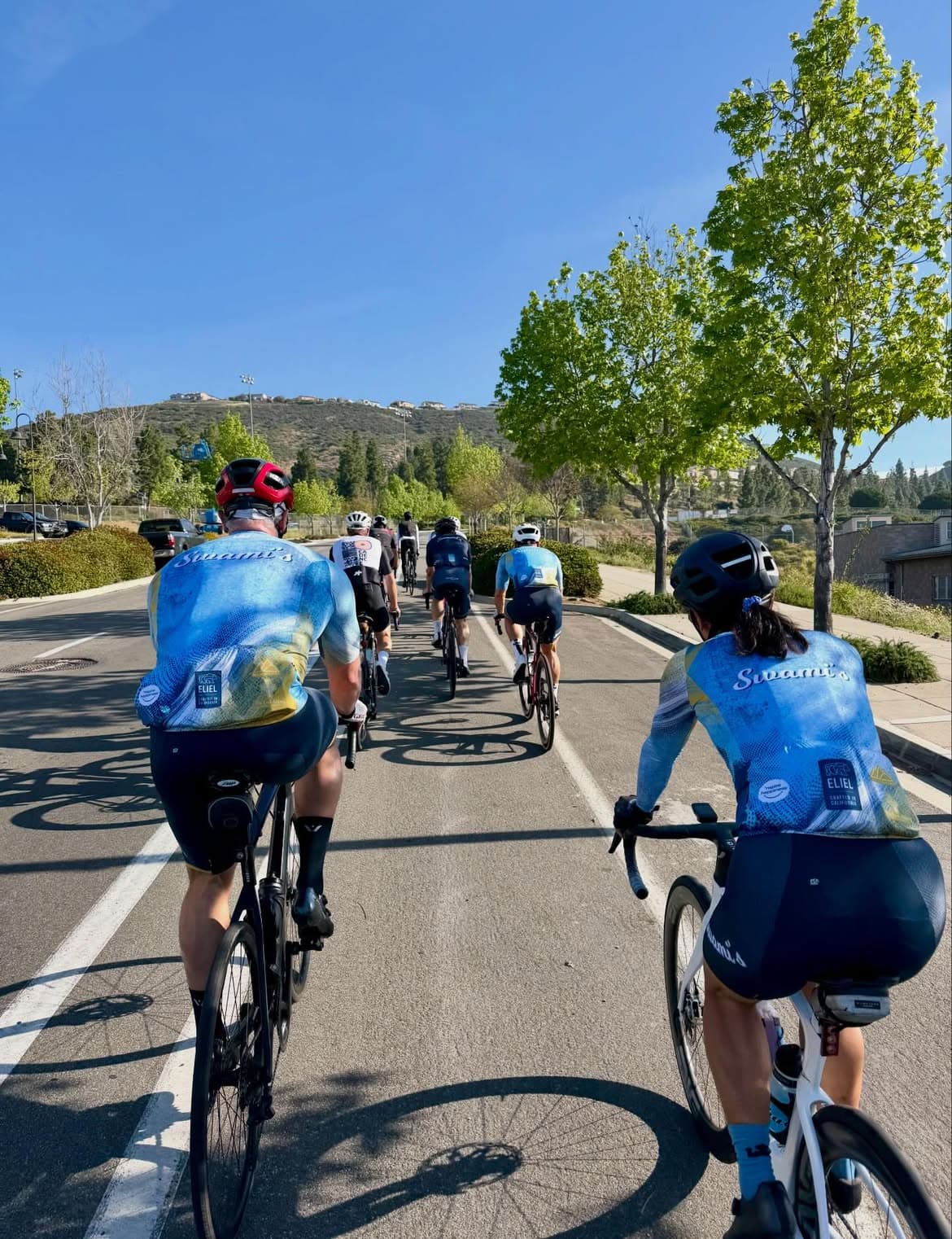 Swami’s team riding together, showing the back graphics of the main kit