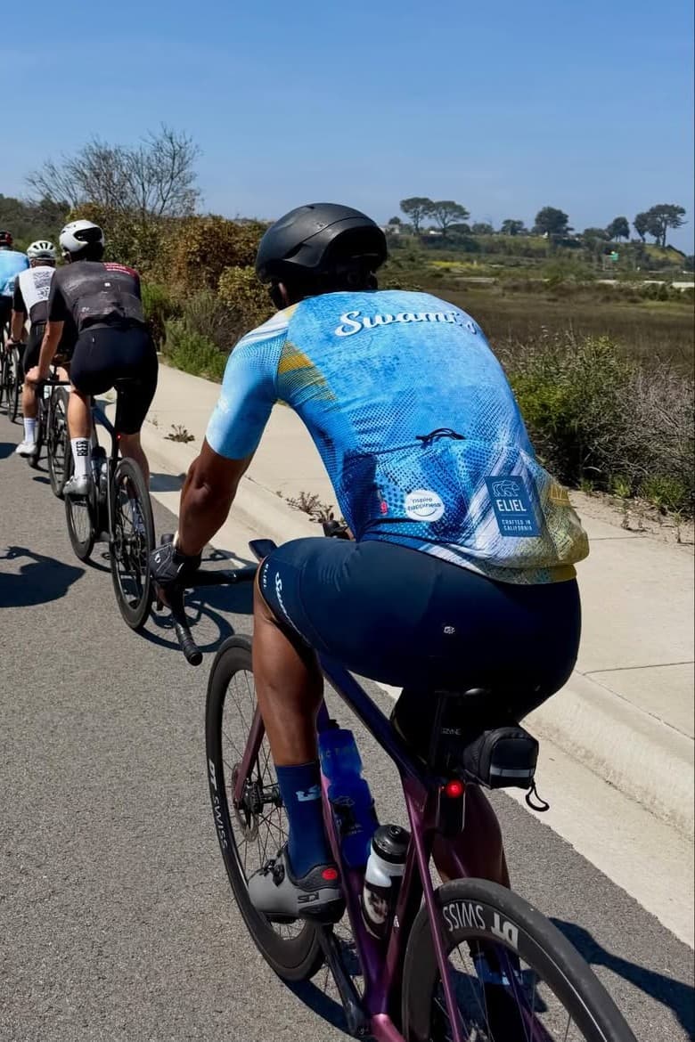 Rear view of the blue Swami’s jersey on a coastal ride